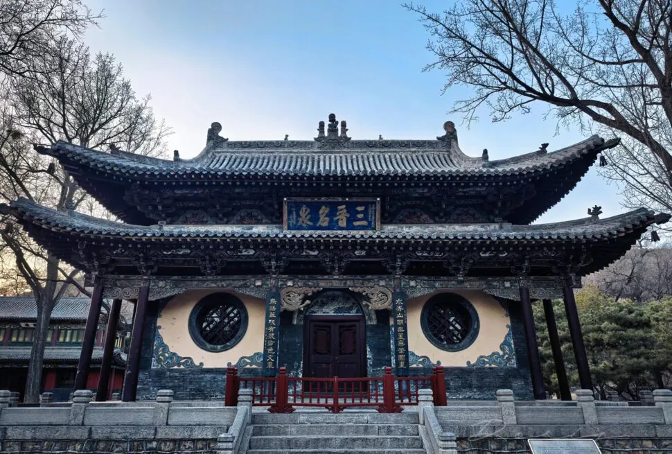 ornate Chinese temple with upturned eaves and intricate woodwork, front steps and circular lattice windows,Jinci Temple,Taiyuan, Shanxi