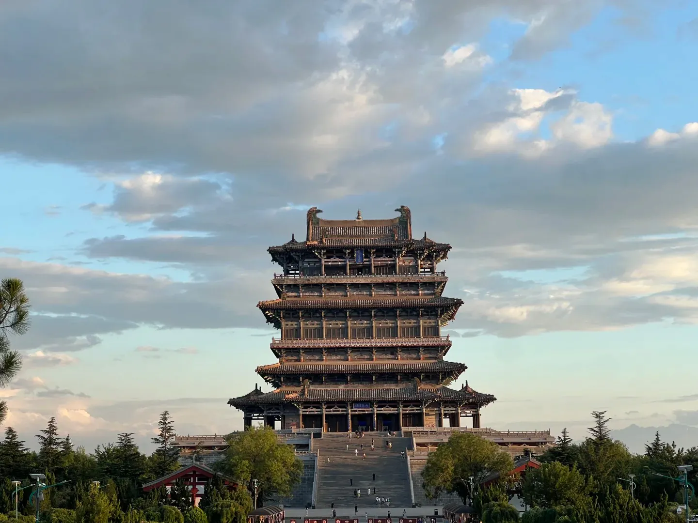 An image of a traditional multi-tiered Chinese pagoda with a cloudy sky background.