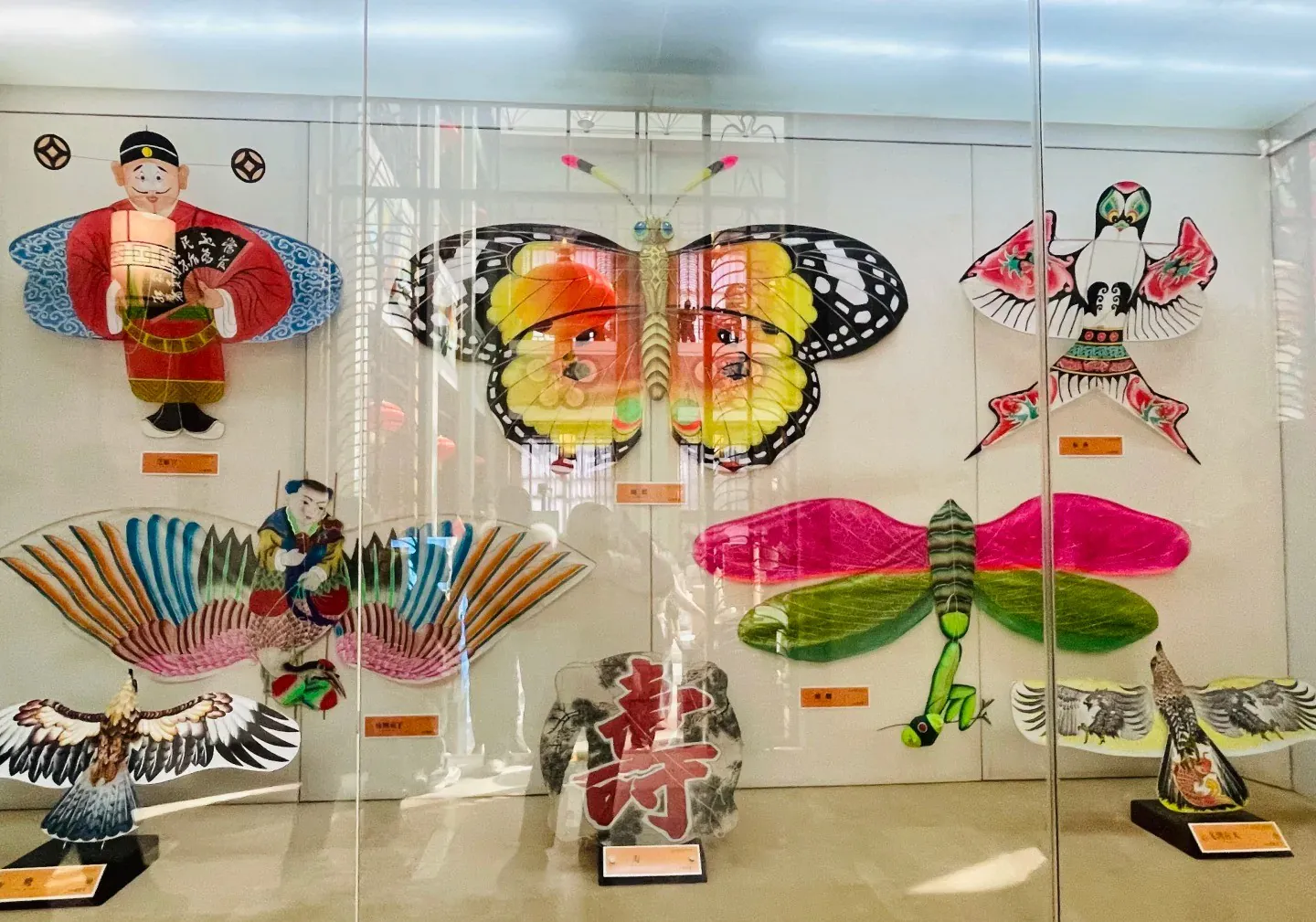A colorful display of traditional Chinese kites featuring a butterfly, dragonfly, and other cultural,Yangjiabu Folk Culture Village,weifang, shandong, chinatravel