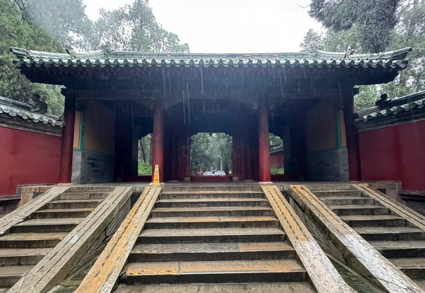 Ancient Chinese temple gate with stone steps and traditional architecture.