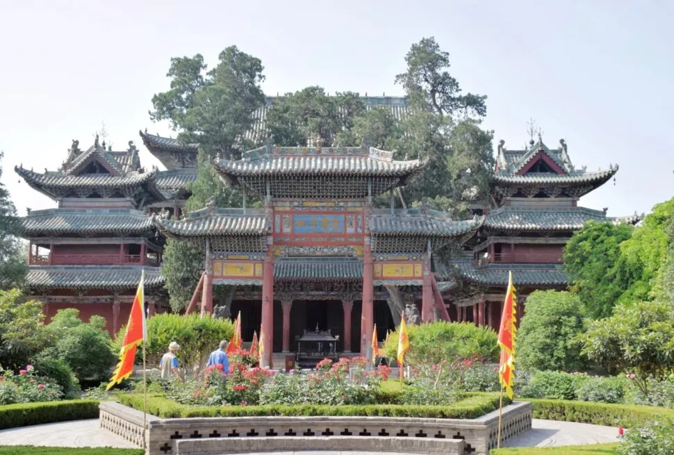 Traditional Chinese temple complex with ornate tiled roofs and red wooden arches, set in a landscaped garden.Xièzhou Guandi Temple,Yuncheng,Shanxi