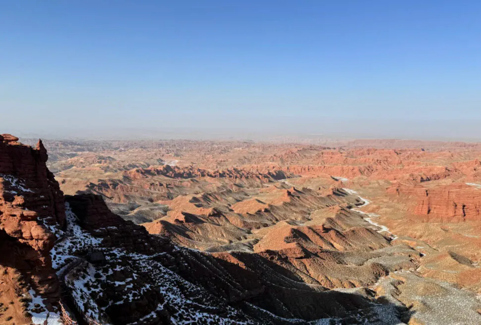 Pingshan Lake Grand Canyon,Zhangye,Chinatrip Grand Canyon with snow on the ridges, showing layered rock formations and a clear blue sky.