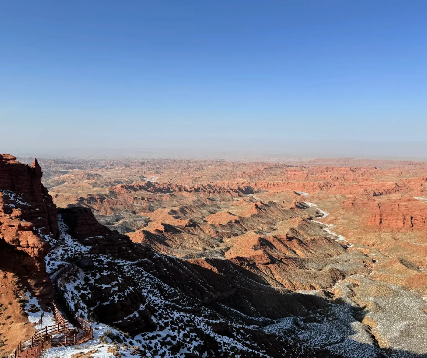 Pingshan Lake Grand Canyon,Zhangye,Chinatrip Grand Canyon with snow on the ridges, showing layered rock formations and a clear blue sky.