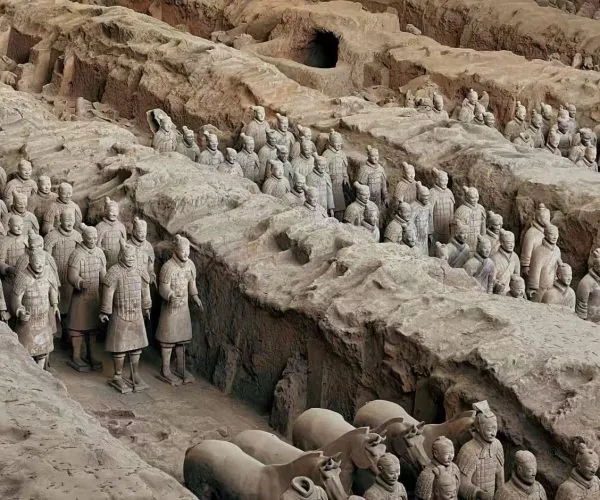 Terracotta Army,Xi`an,Chinatour Row of life-sized terracotta soldiers emerging from an excavation pit in China.