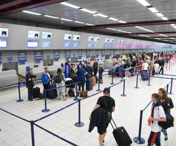 airport, chengdu, chinatravel, Busy airport check-in area with many passengers lined up along blue stanchions and several service counters with overhead screens.