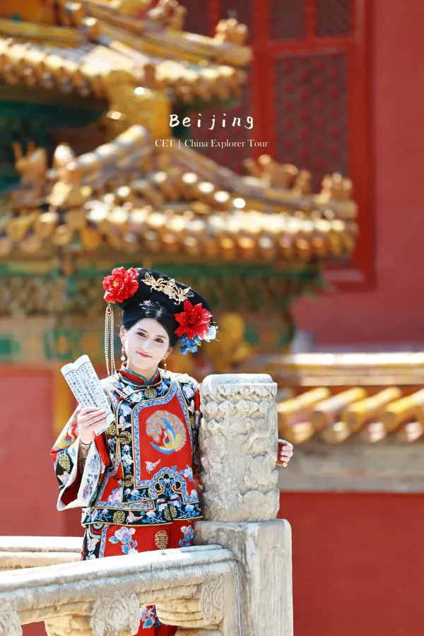 hanfu photoshoot, the forbidden city, beijing, qing dynasty, female, solo, chinatravel, Person in an ornate traditional Chinese opera costume posing by a carved stone railing at a Beijing temple, with colorful architecture in the background.