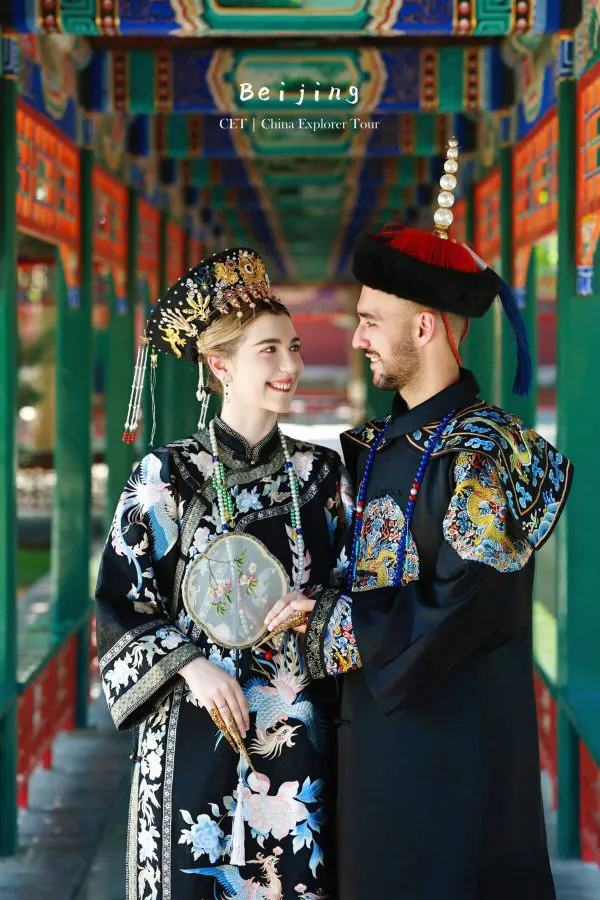 hanfu photoshoot, zhongshan park, beijing, couple, chinatrip, Couple in elaborate traditional Chinese outfits posing together under a colorful Beijing temple corridor.