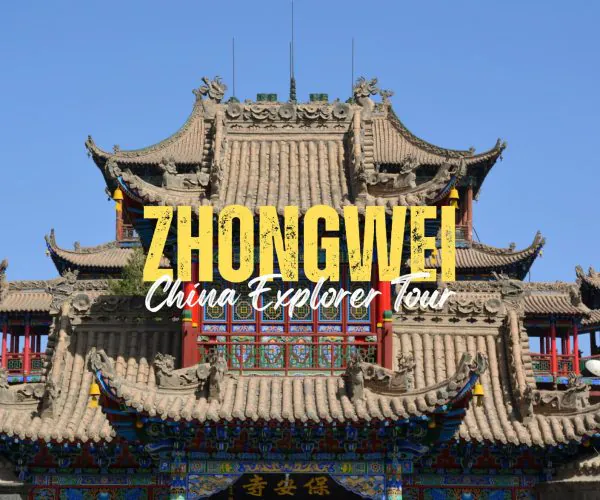 Zhongwei,Ningxia,China tour Promotional banner for Zhongwei China Explorer Tour over a traditional Chinese temple façade.