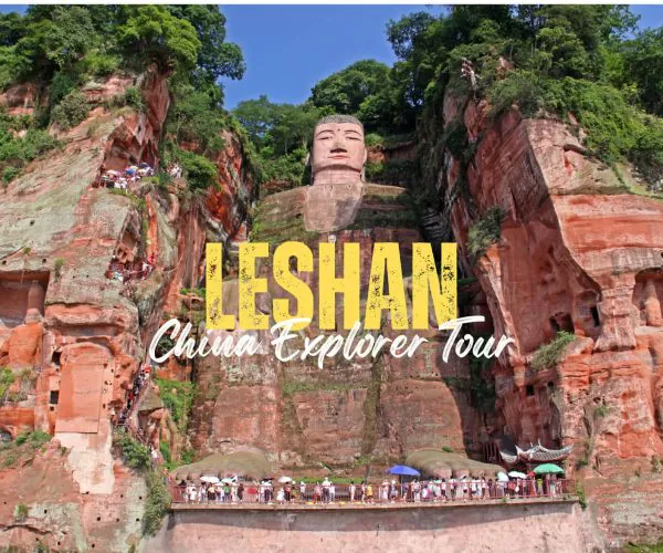 Leshan,Sichuan,Chinatravel Cliffside view of the Leshan Giant Buddha carved into red rock with tourists at the base and viewing platforms.