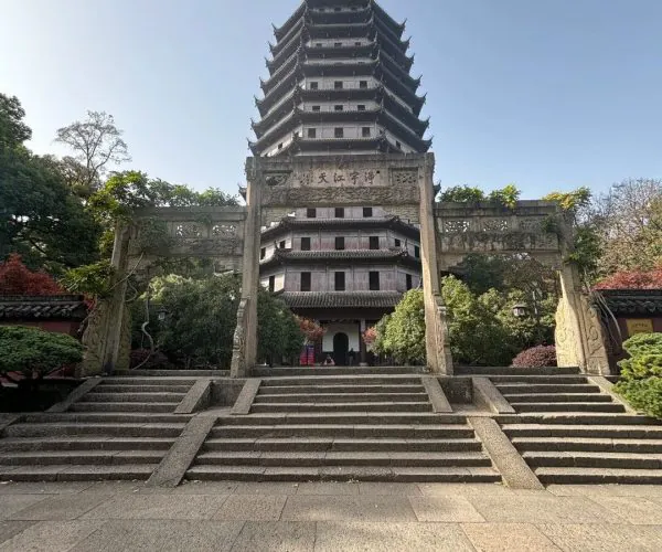 Six Harmonies Pagoda,Hangzhou,Chinatravel Stone steps lead up to a multi-tier Chinese pagoda framed by a carved stone arch in a tranquil garden setting