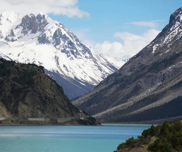 Nyingchi,Tibet,Chinatour Snow-capped mountains and turquoise lake in a scenic Chinese landscape.