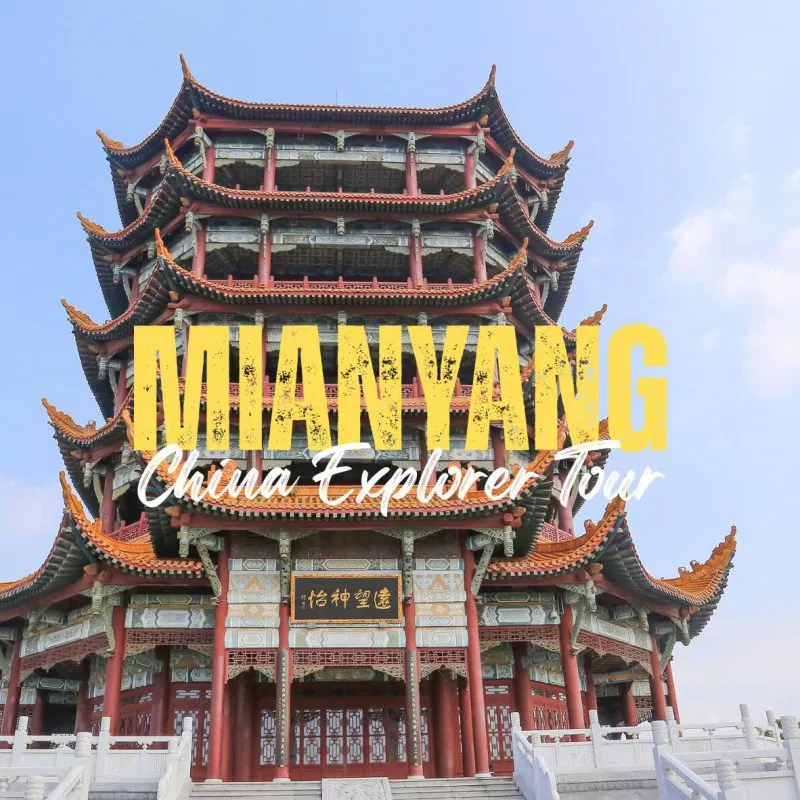 Mianyang,Sichuan,Chinatravel Three-tier Chinese pagoda with red columns and orange roof against a blue sky, with 'DUAN YANG' and 'China Explorer Tour' text overlay.